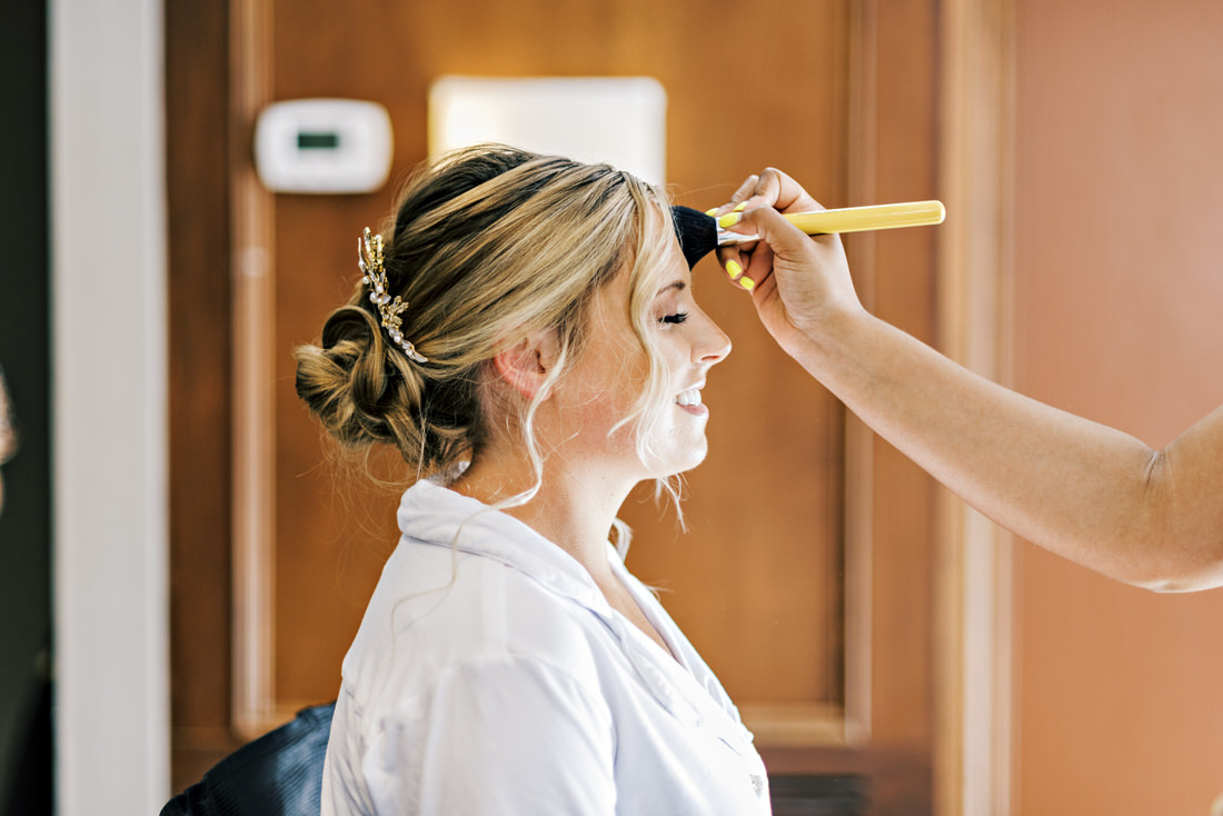 Bride getting her makeup done at the Bostonian Hotel