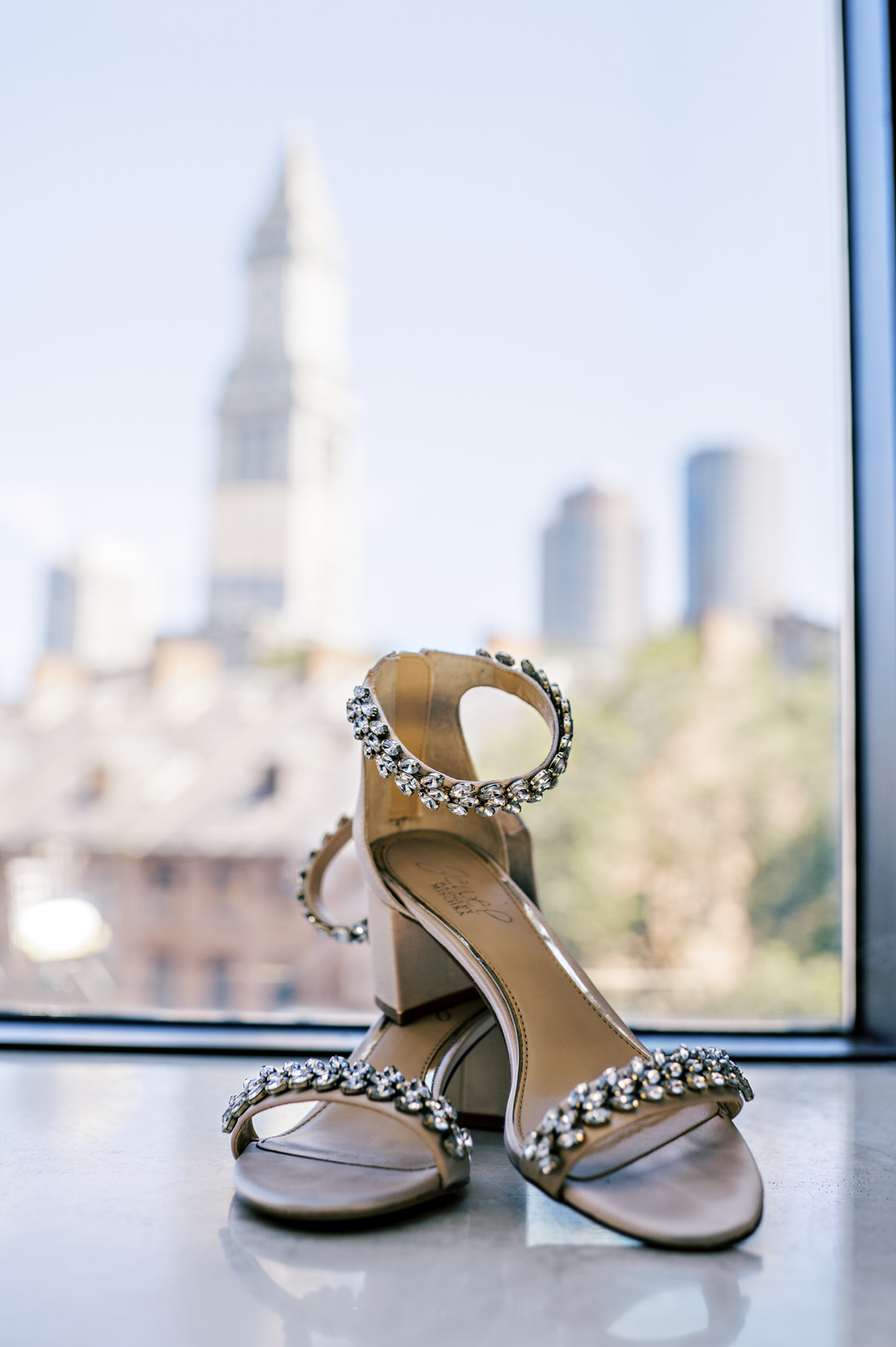 Bride's shoes with Boston skyline in the back at the Bostonian Hotel