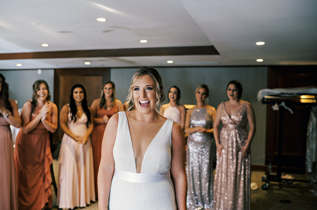 Bridesmaids seeing the bride in her dress for the first time