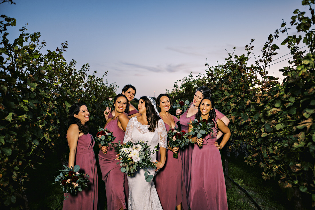 Bridesmaids posing among the vines