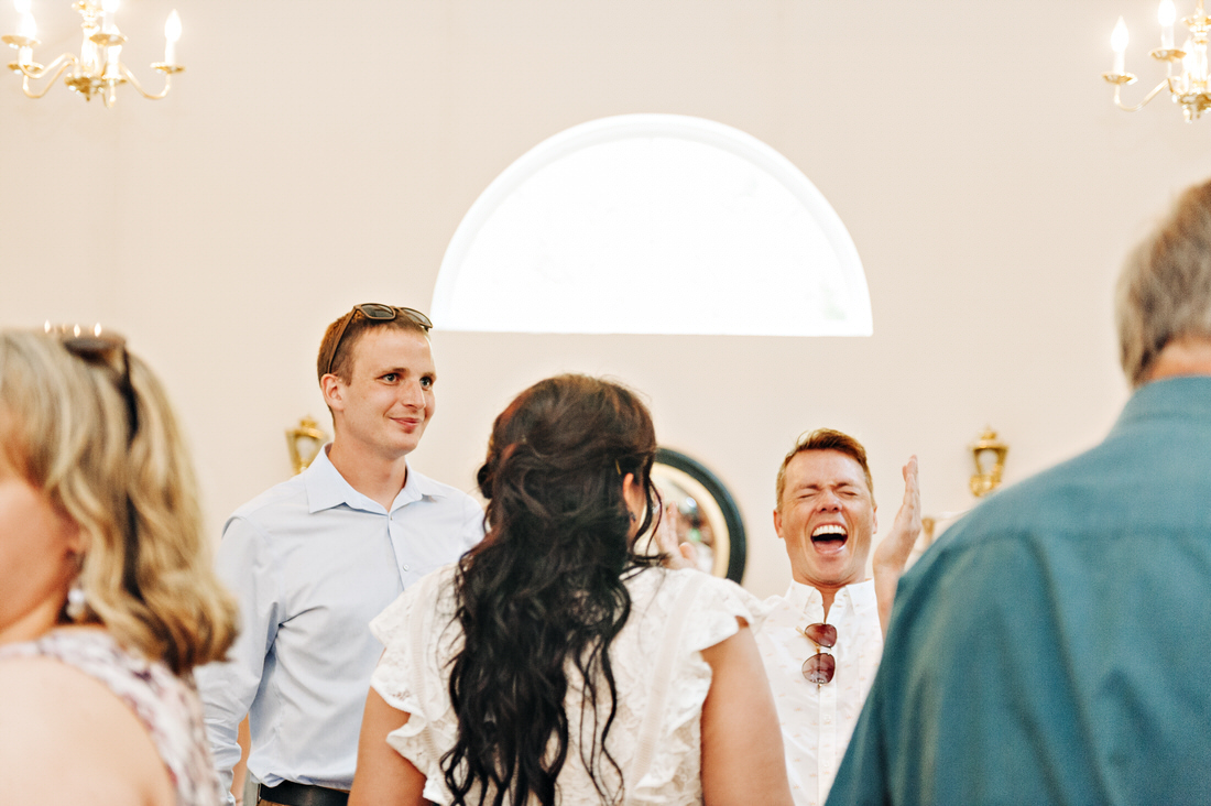 Guests laughing at cocktail hour