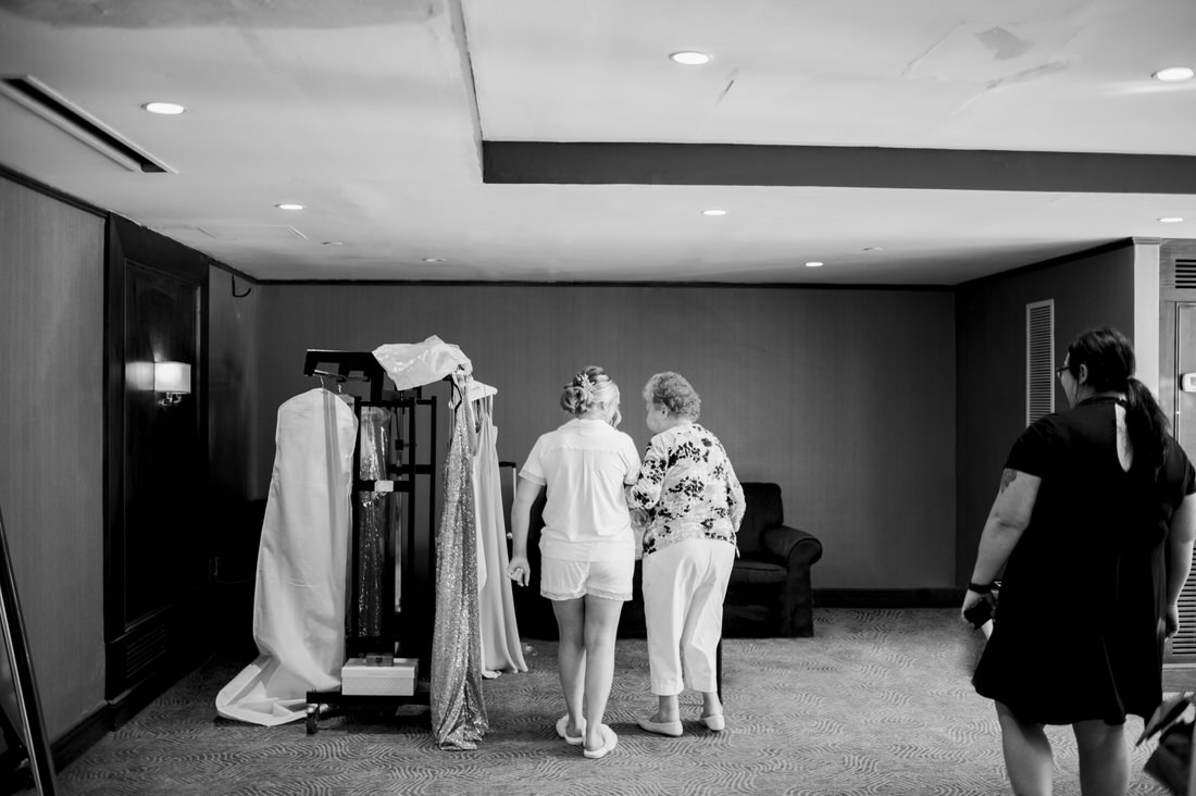 Grandmother and granddaughter looking at wedding dress