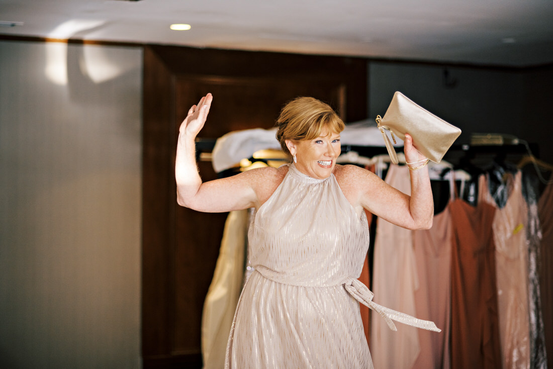 Mother of the bride smiling and dancing at the Bostonian Hotel