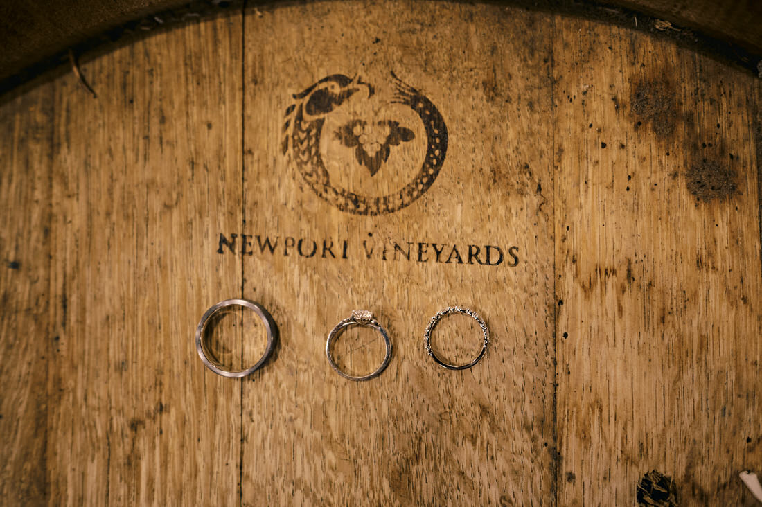 Bride and groom's rings on a Newport Vineyard wine barrel