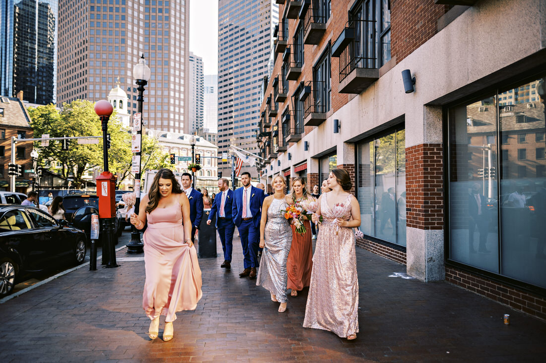 Wedding party walks down Boston street