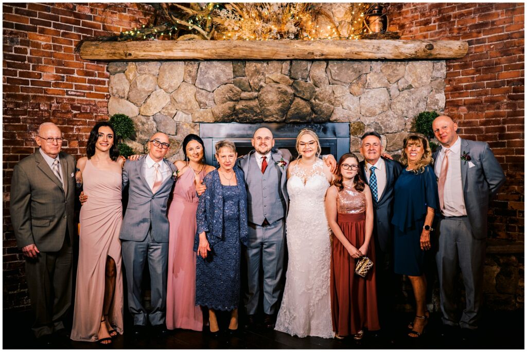 bride and groom posing for large family portrait at 1620 Winery