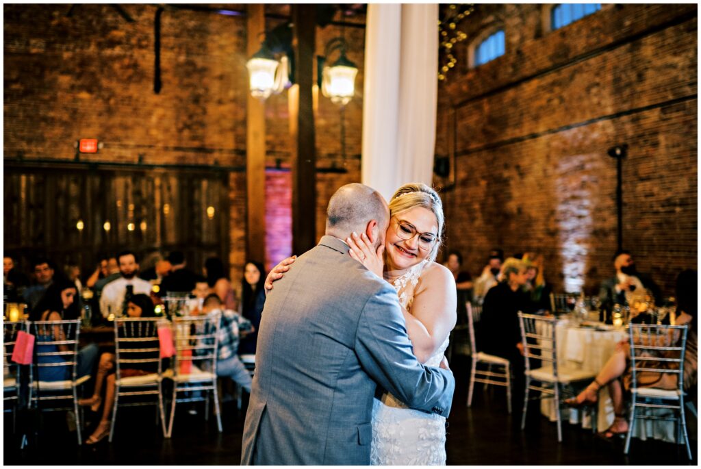 bride and groom embracing during their first dance