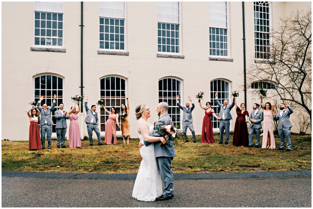 bride and groom and their wedding party cheering