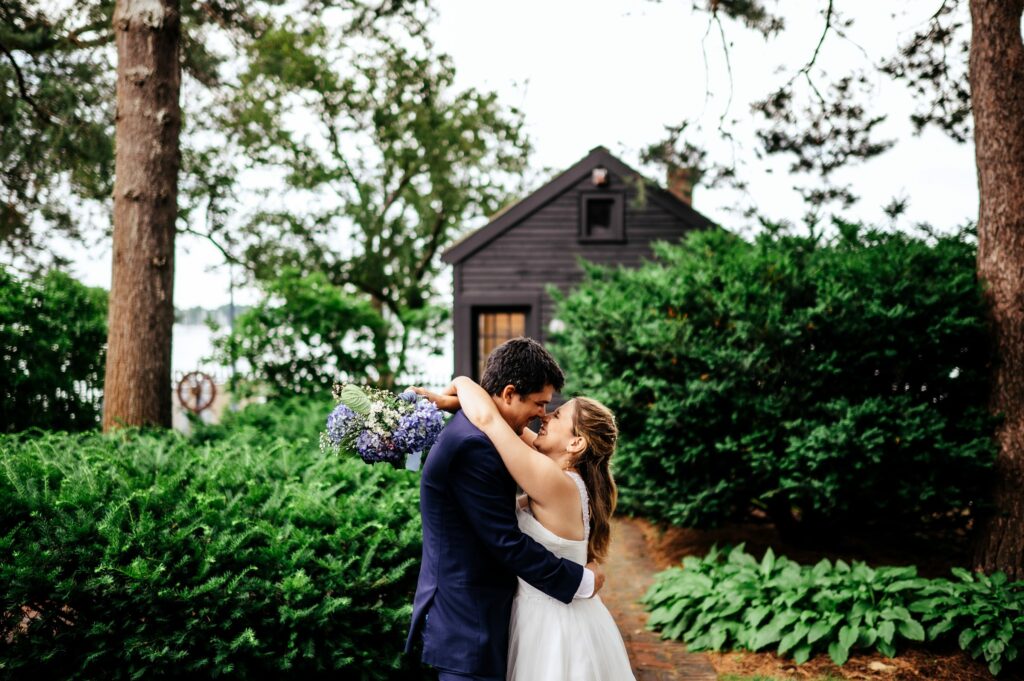 Bride and groom portrait taking in the garden of The House of Seven Gables