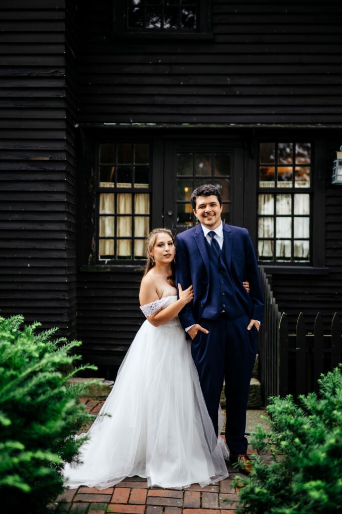 Bride and groom portrait taking in the garden of The House of Seven Gables