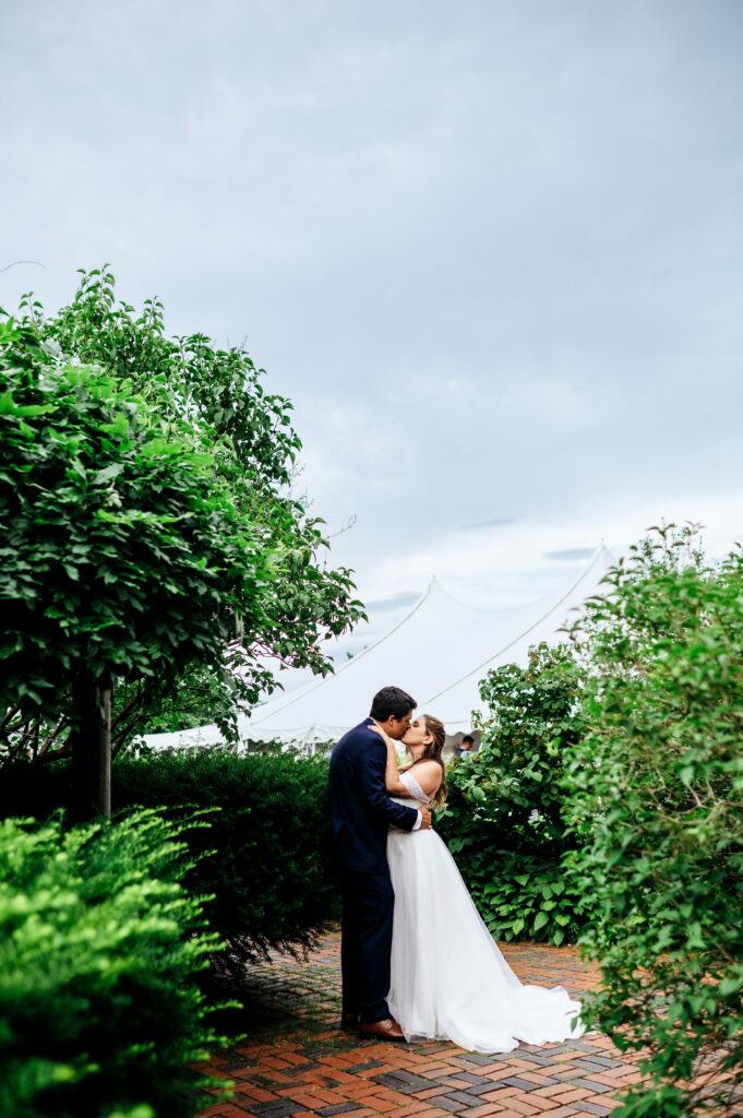 Bride and groom portrait taking in the garden of The House of Seven Gables