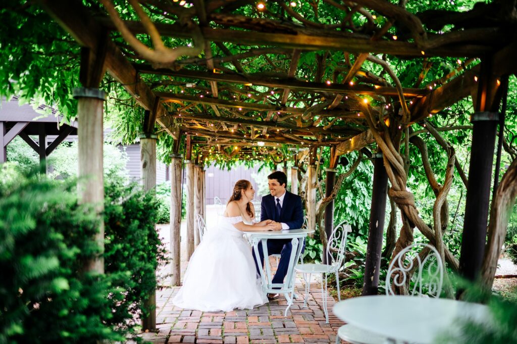 Bride and groom portrait taking in the garden of The House of Seven Gables