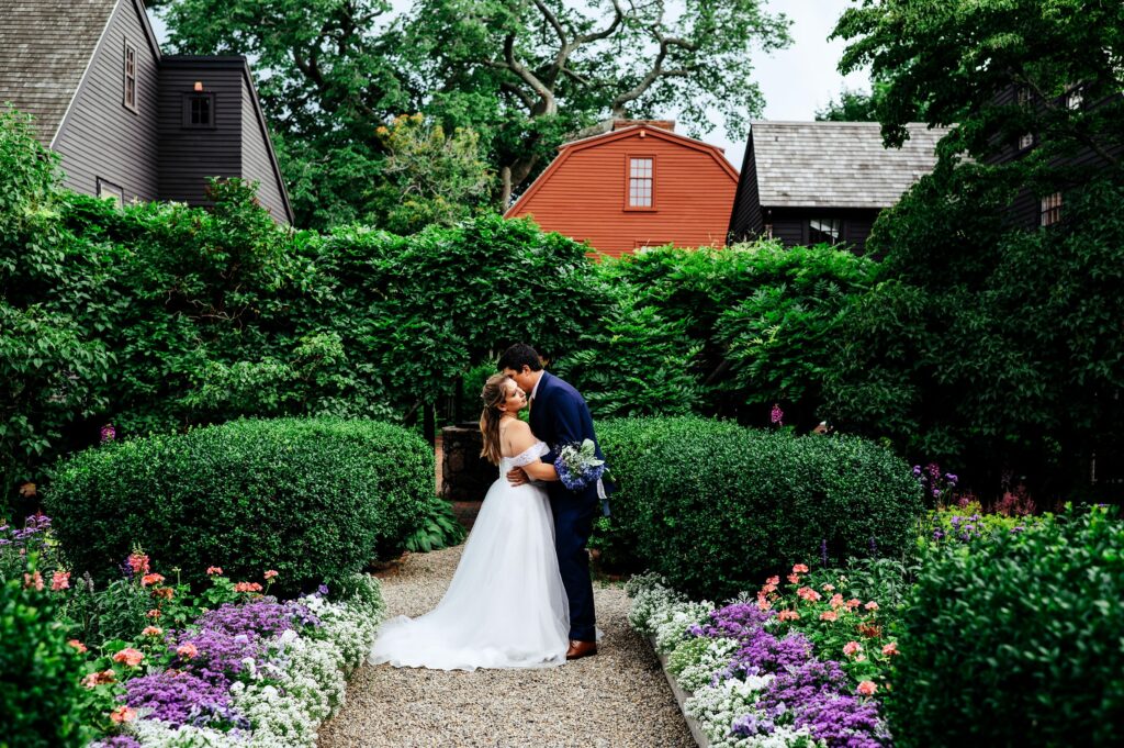 Bride and groom portrait taking in the garden of The House of Seven Gables