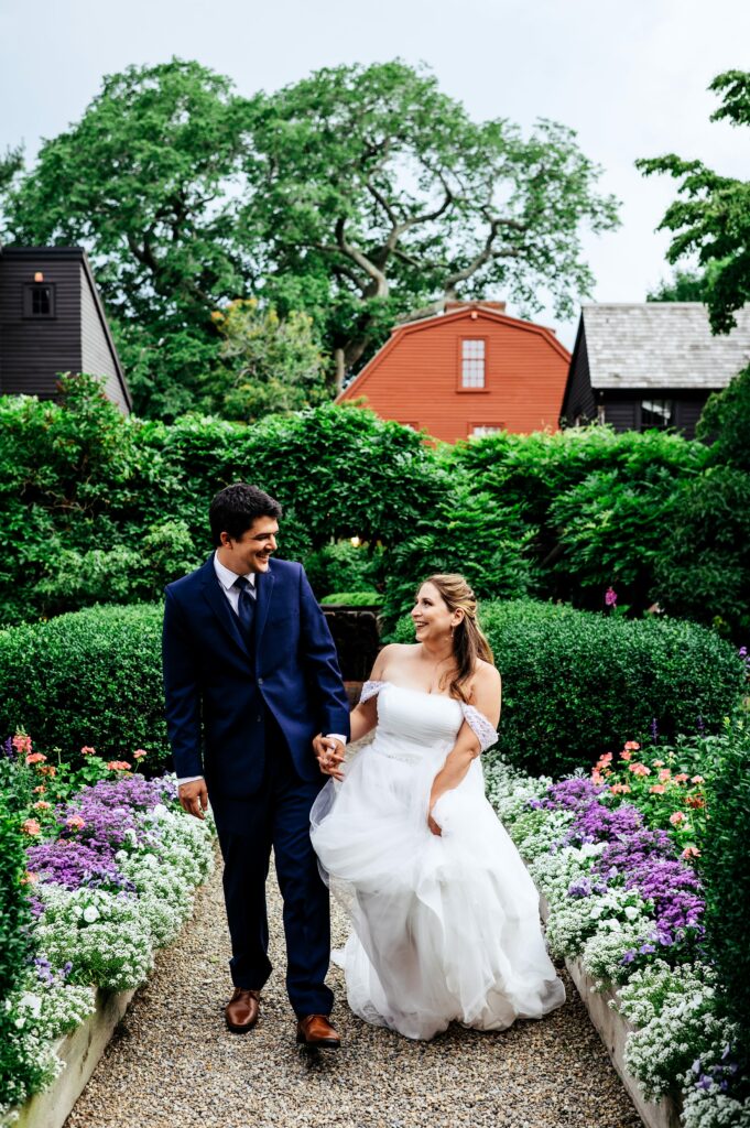 Bride and groom portrait taking in the garden of The House of Seven Gables