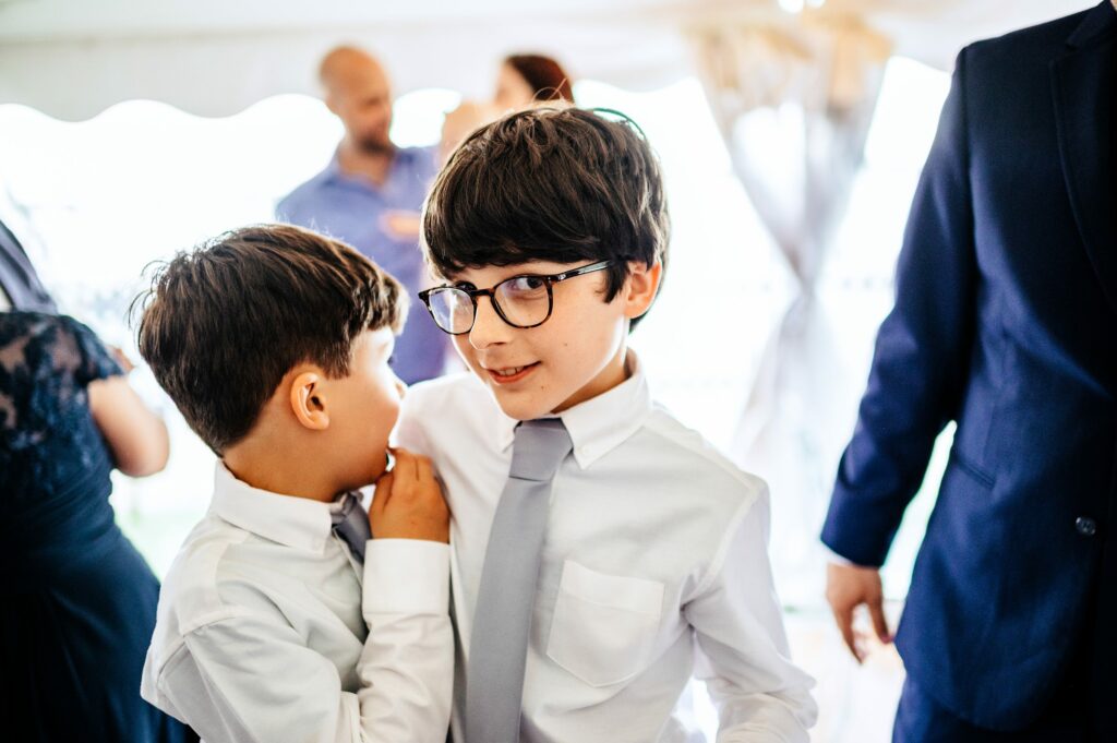 Candid photos during tented wedding reception at The House of Seven Gables