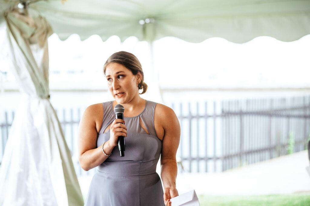 Candid photos during tented wedding reception at The House of Seven Gables