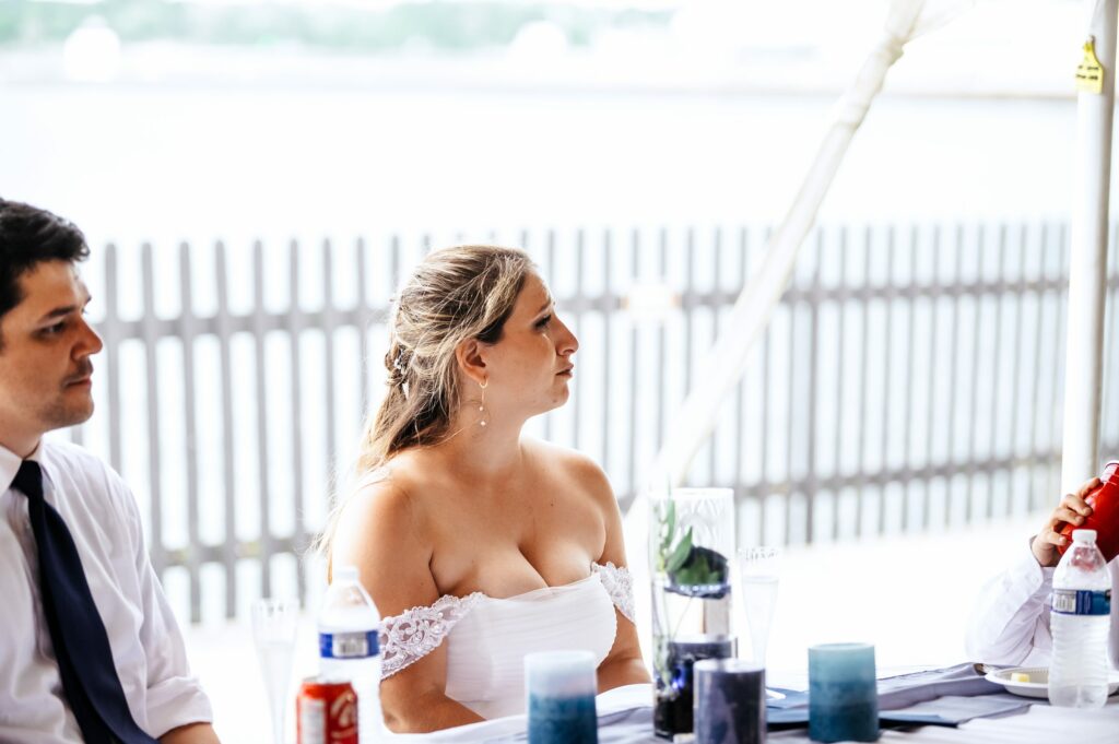 Candid photos during tented wedding reception at The House of Seven Gables