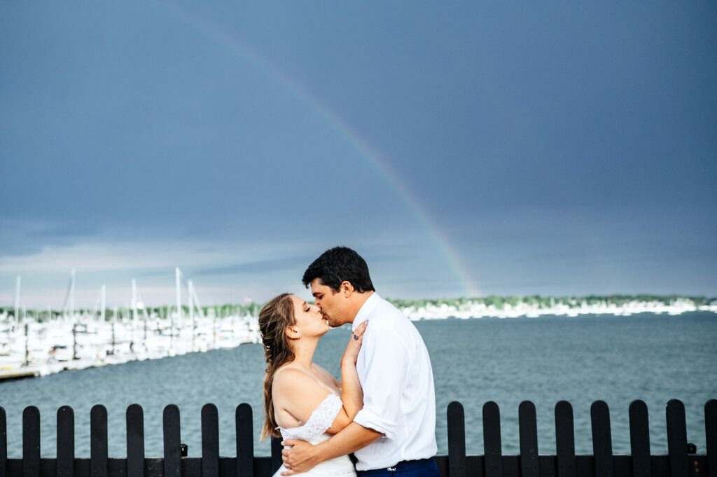 Bride and groom portrait with rainbow in the background in Salem, MA