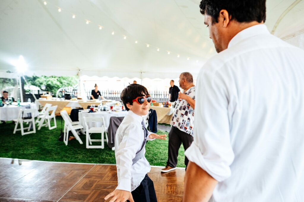 Boy dancing on the dance floor wearing sunglasses 