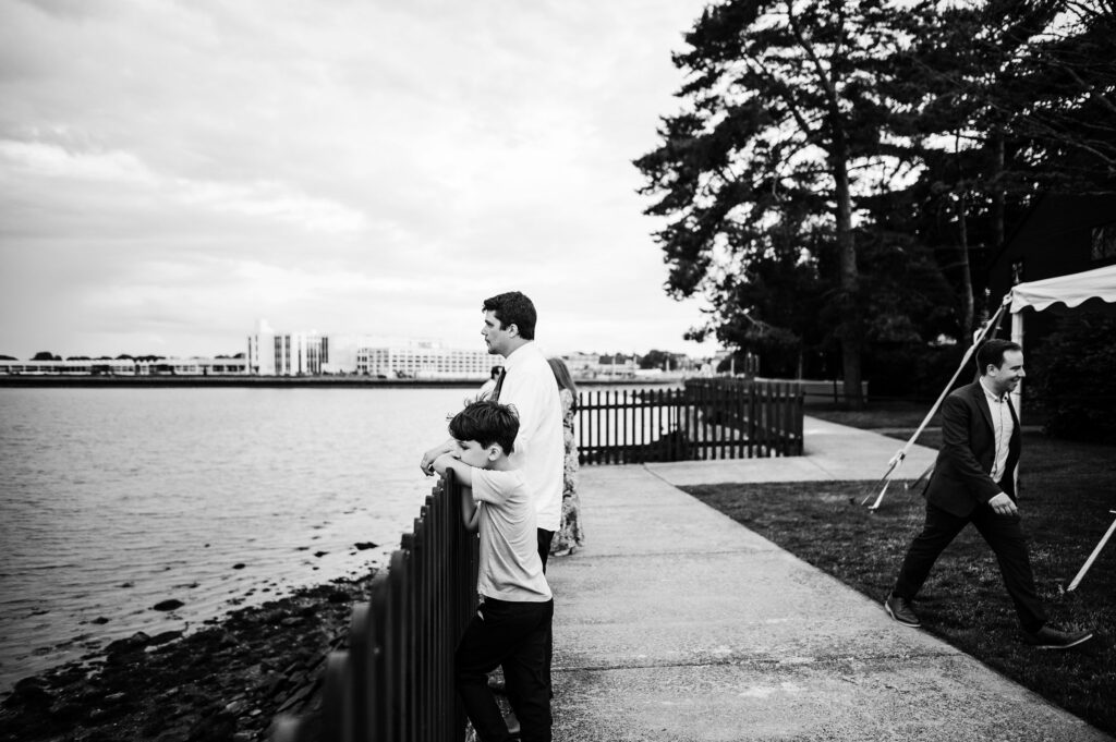 Groom and his son looking out over Salem Harbor