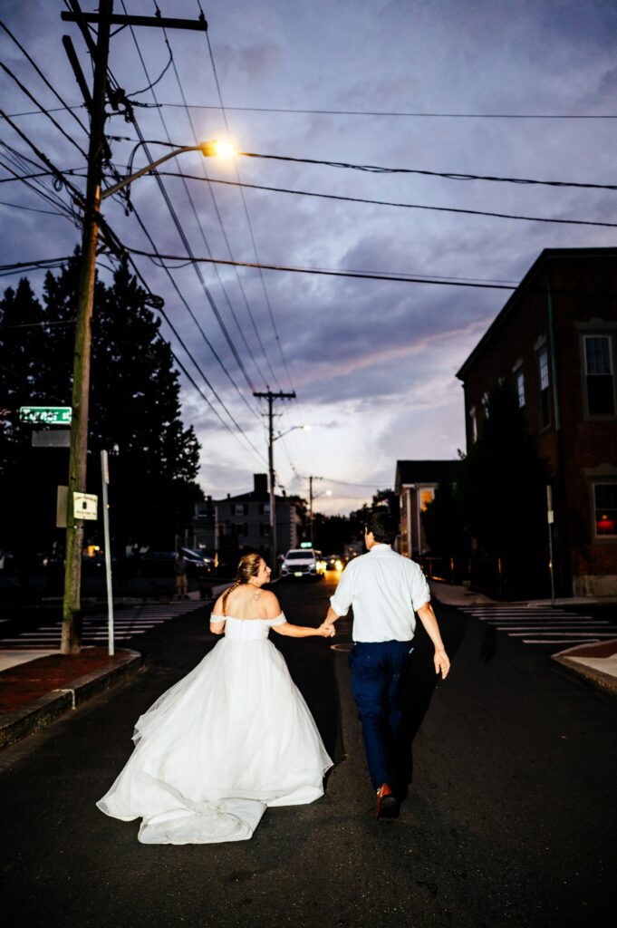 Bride and groom walking through the streets of Salem, MA