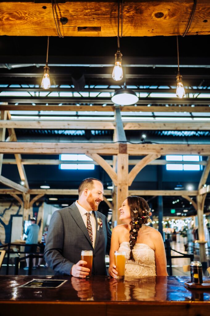 Bride and groom standing at the bar at Tree House Brewing Co. in Sturbridge, MA