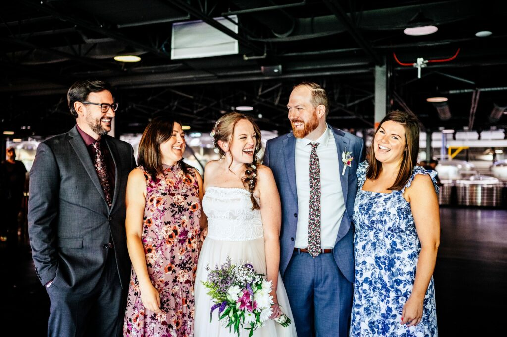 Candid photo of bride and groom with friends 