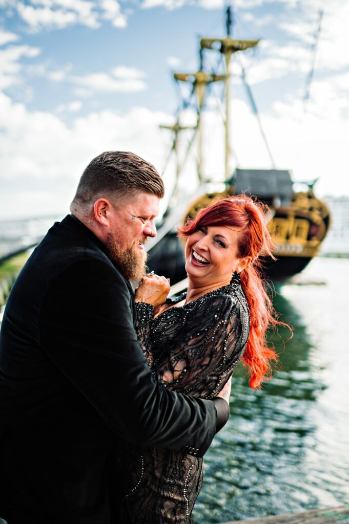 Bride and groom candid laughing portrait on the Salem waterfront 