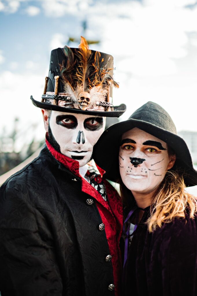 Guests dresses in costumes with face paint for Salem Halloween wedding