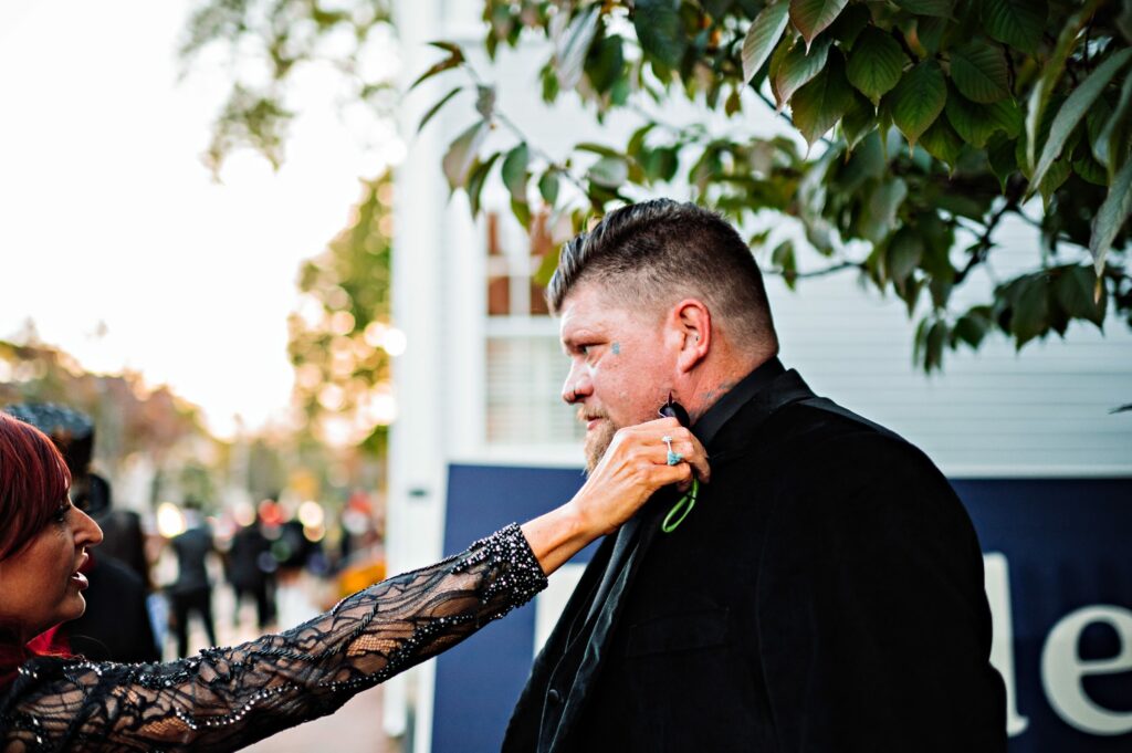 Bride helping groom with boutonniere 