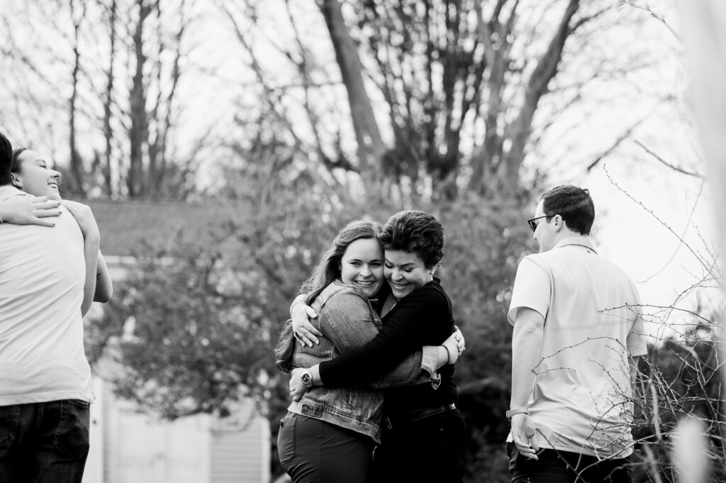 Woman hugging her mom after proposal 