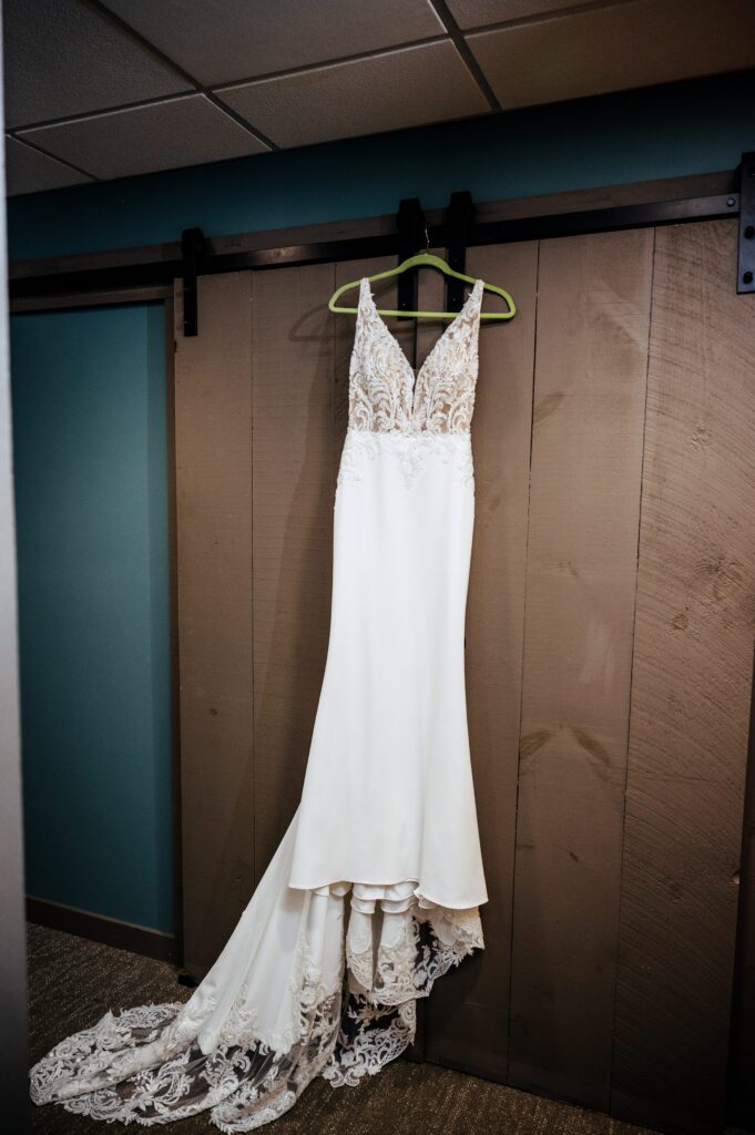 Wedding gown hanging in bridal suite 