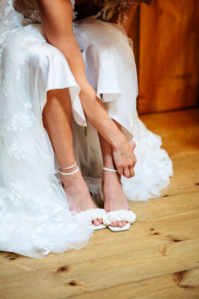 Bride adjusting her shoes