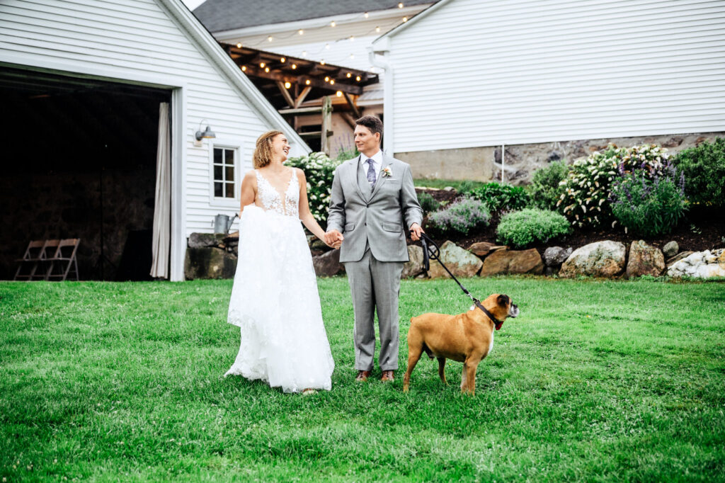 Bride and groom walking together with their dog at South Farms