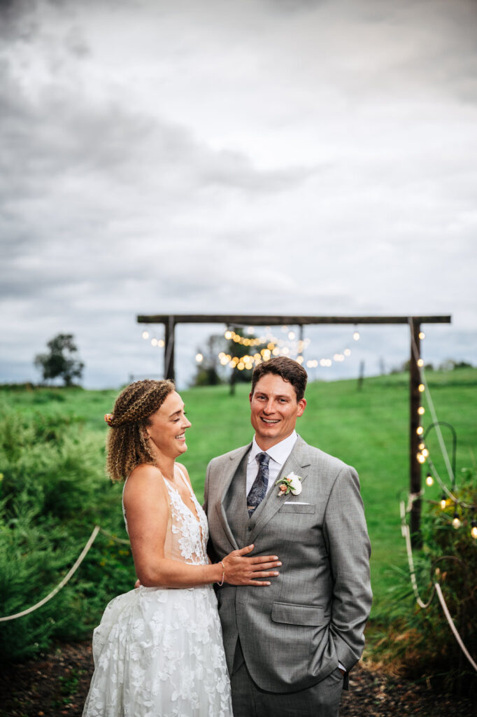 Bride and groom smiling outside