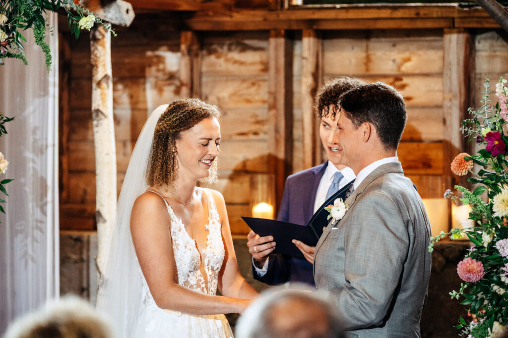 Bride and groom laughing during their wedding ceremony