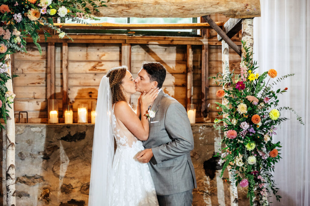 Bride and groom kissing at the end of their ceremony