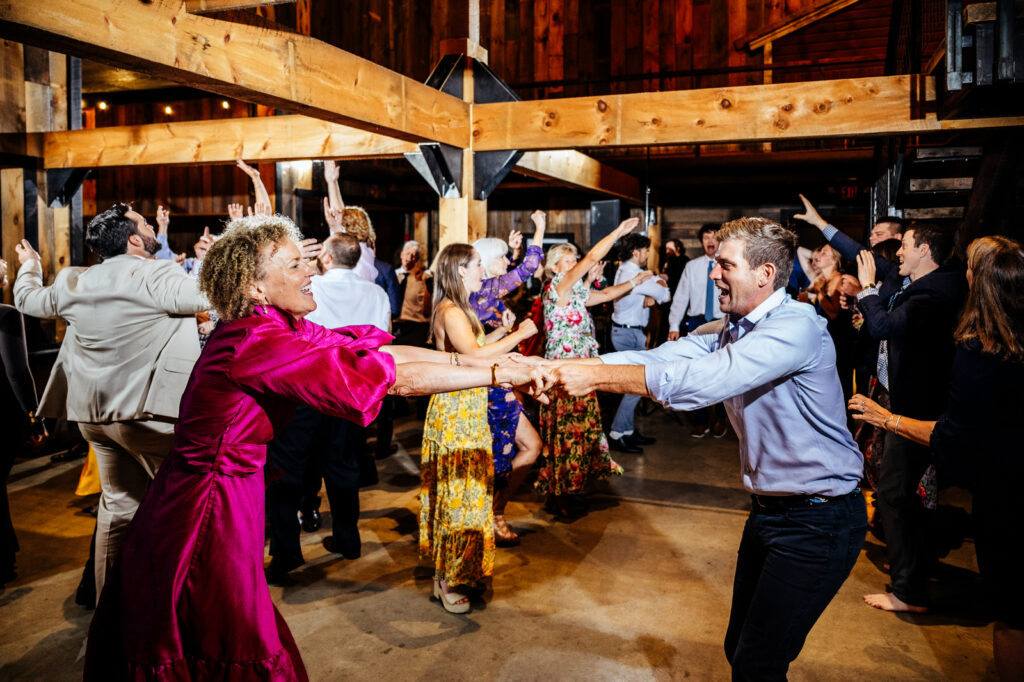 Bride and guest dancing during wedding reception