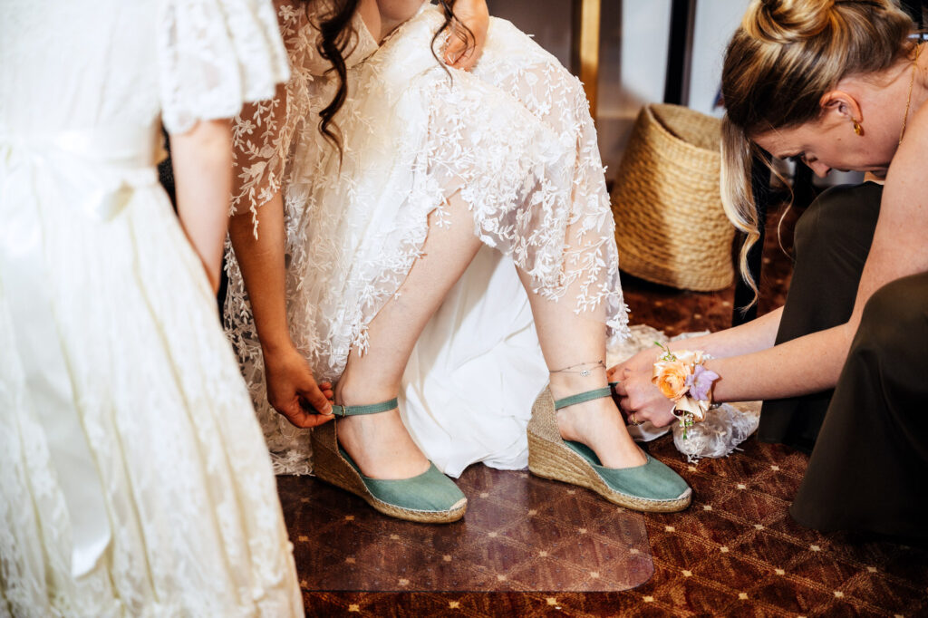 Bride getting her shoes on