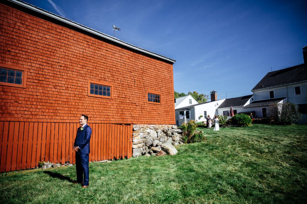 Bride and groom first look outside of a barn in New Hampshire