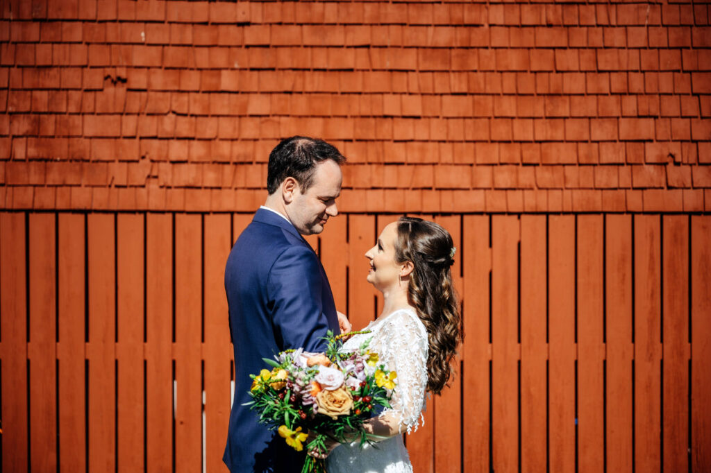 Bride and groom first look outside of a barn in New Hampshire
