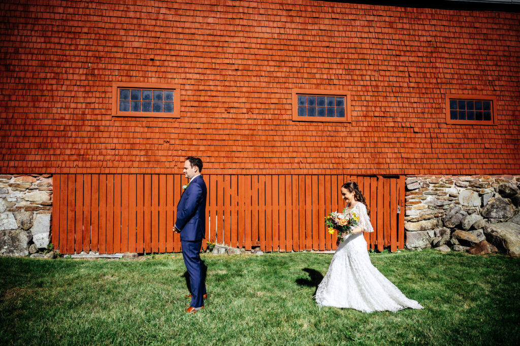 Bride and groom first look outside of a barn in New Hampshire