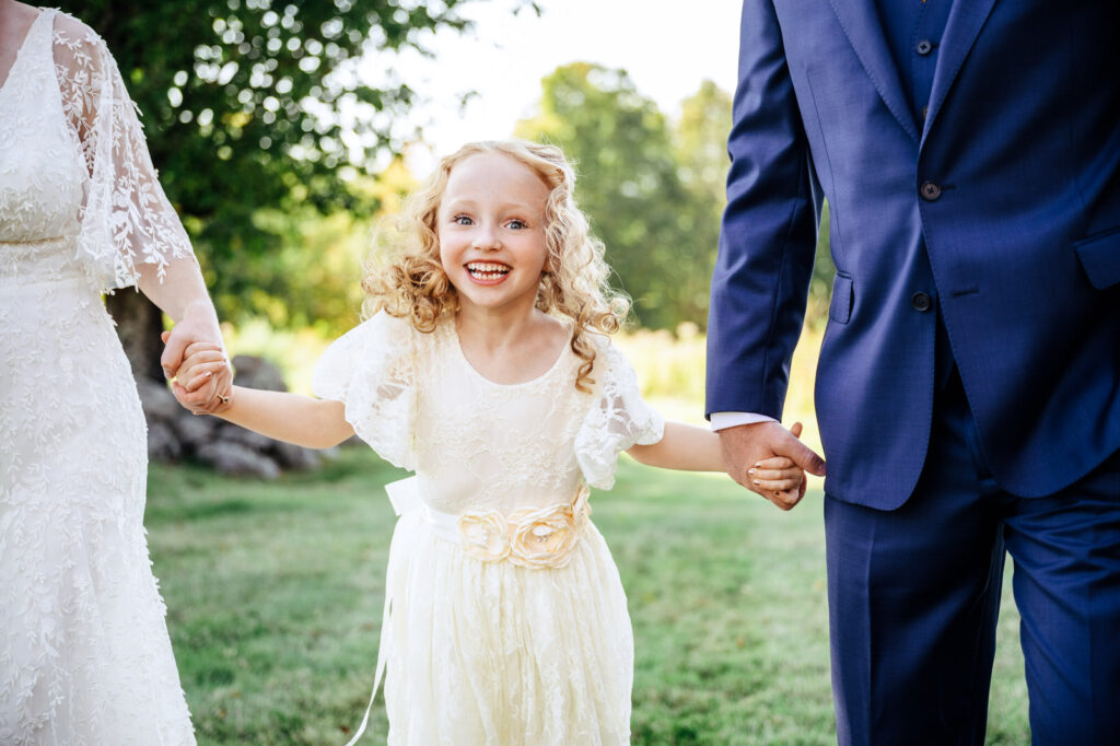 Bride's daughter smiling during portrait time