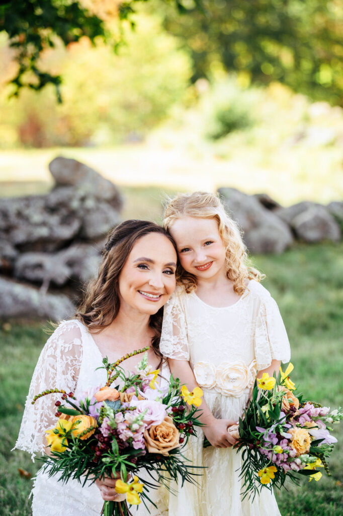 Bride and her daughter on her wedding day posing for photos 